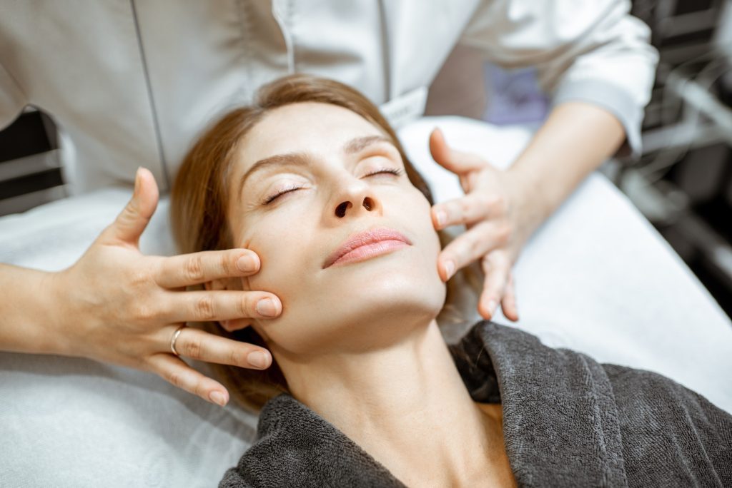 Woman during the facial massage at the beaty salon